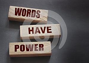 Words Have Power - text on wooden blocks on dark grey background. Powerfull force of communication, storytelling business concept