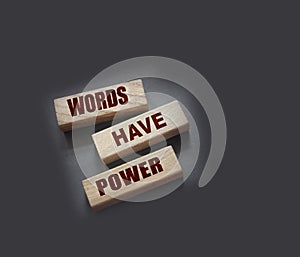 Words Have Power - text on wooden blocks on dark grey background. Powerfull force of communication, storytelling business concept
