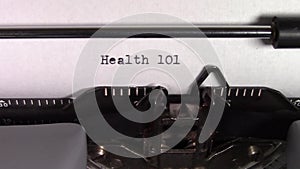 The words `Health 101 ` being typed on a typewriter