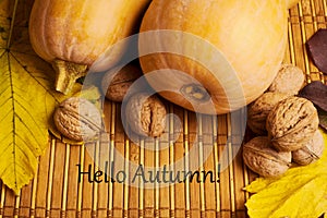 Words hello autumn on rustic background