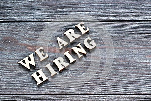 Words We are hiring on wooden background. Job board. Human Resource Management and Recruitment and Hiring concept.