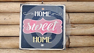 The words `Home sweet home` on the wooden boards
