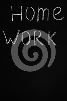 Words `home work` drawing on chalkboard with copy space . Blackboard inscription vertical. Learning message. Home education.