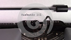 The words `Husbands 101 ` being typed on a typewriter