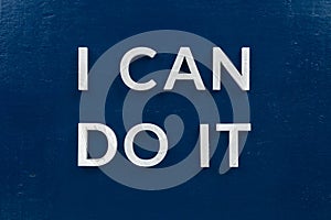The words i can do it laid with white metal letters on dark blue flat background