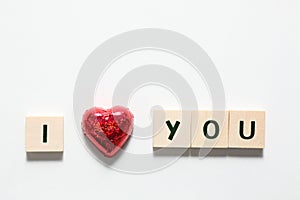 Words i love you made of wooden blocks and a red heart isolated on white background
