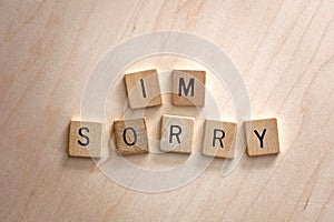 Words I`m Sorry Spelled out in Wooden Letter Blocks on Wood Background