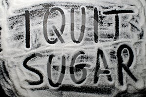 Words I quit sugar written in and with sugar, concept of diet ch