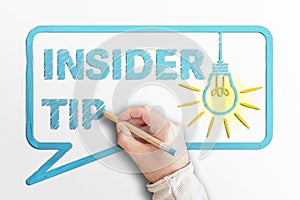 Words INSIDER TIP in speech bubble with glowing light bulb photo