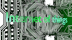 Words Internet of things in green on top of circuit board