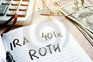 Words IRA 401k ROTH handwritten in a note. Retirement plans. photo