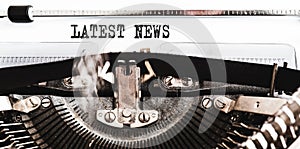 Words LATEST NEWS written on old manual typewriter