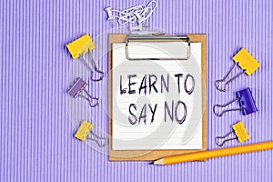 The words Learn to say no written on a white notebook. Work and study concept