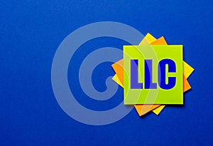The words LLC Limited Liability Company is written on bright stickers on a blue background