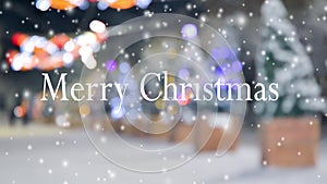 Words Merry Christmas on blurred background of Christmas trees street snowfall