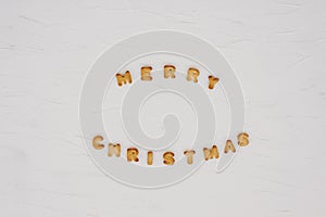 The words merry christmas and happy new year are written from cookie letters. Flat lay composition for greeting card