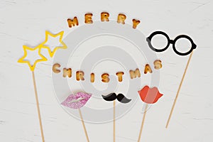 The words merry christmas and happy new year are written from cookie letters. Flat lay composition for greeting card
