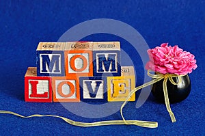 The words mom love spelled with alphabet blocks