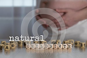 Words NATURAL CHILDBIRTH composed of wooden letters