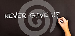 Words Never Give Up written on a blackboard