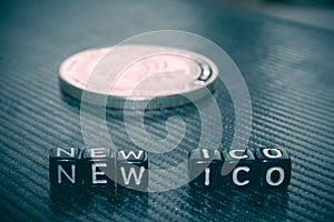 Words new ico of black cubes and silver coin dark.
