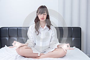 The words NO!. Portrait of a young attractive woman showing stop sign with hand on her bedroom