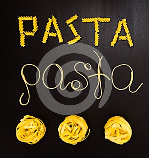 Words pasta made of cooked spaghetti and dry pasta on the black background with frame of country Italy written by chalk