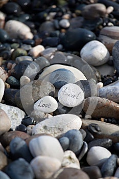 Words on pebble stones motivational concept slogan â€“ words love, travel, enjoy