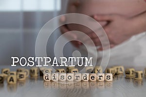 Words POSTPARTUM DISORDERS composed of wooden letters photo