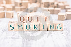 The Words Quit Smoking Formed By Wooden Blocks On A White Table, Reminder Concept