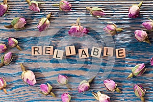 Reliable on wooden cube photo