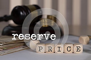 Words RESERVE PRICE composed of wooden dices