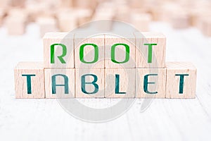 The Words Root Tablet Formed By Wooden Blocks On A White Table