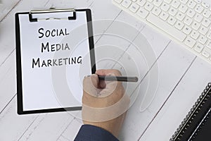 Words Social Media Marketing on a paper with black clipboard.