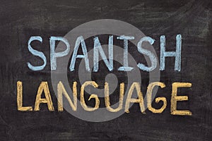 The words Spanish Language written in chalk on a blackboard