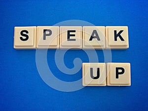 Words of SPEAK UP on cube blocks representing business culture. Business concept