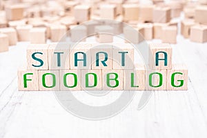 The Words Start A Foodblog Formed By Wooden Blocks On A White Table