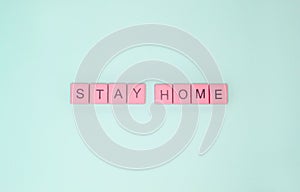 Words `stay home` made of pink wooden letters