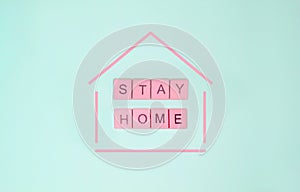 Words `stay home` made of pink wooden letters