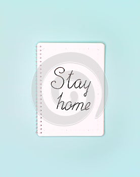 Words `stay home` written in notepad.