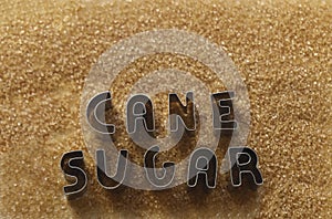 words stop eat made from metal letters. pile of cane brown sugar isolated on white background