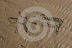 Words sunny day written in the sand