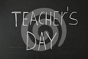 Words TEACHER`S DAY written with chalk on blackboard