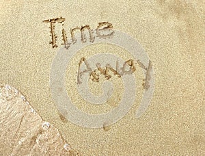 The Words Time Away Written in Sand With Footprints and Ocean Wave