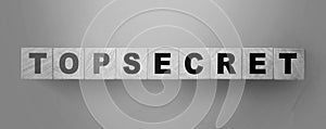 Words Top secret on wooden cubes on green background. Trading or big profit secrets business concept