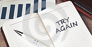 The words Try Again written on a white notebook. Work and study concept