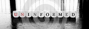 Words uninformed or informad - dilema concept photo