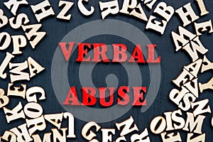 Words verbal abuse and wooden letters around. photo