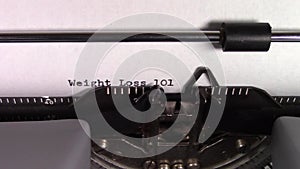 The words `Weight Loss 101 ` being typed on a typewriter