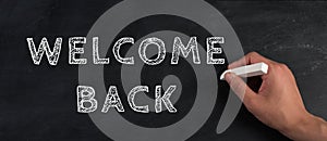 The words welcome back are standing on a chalkboard, reopen post covid-19 pandemic, back to normal